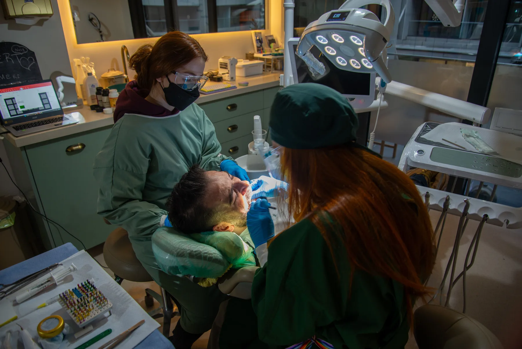 Dental tools and a jaw model arranged for gum and tooth-support care planning.