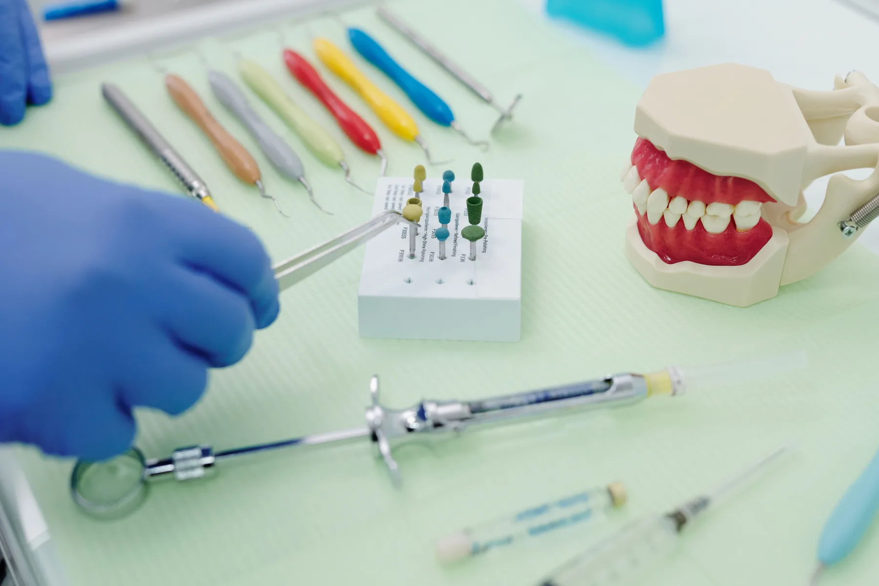 Periodontal scalers, dental tools, and a gum model prepared for gum disease assessment.