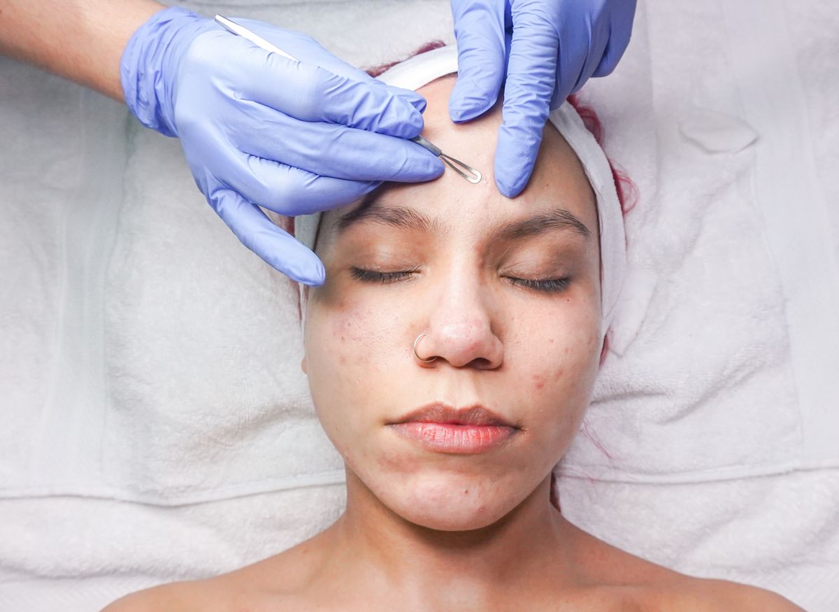 Client receiving a professional facial skin treatment; illustrative stock image.