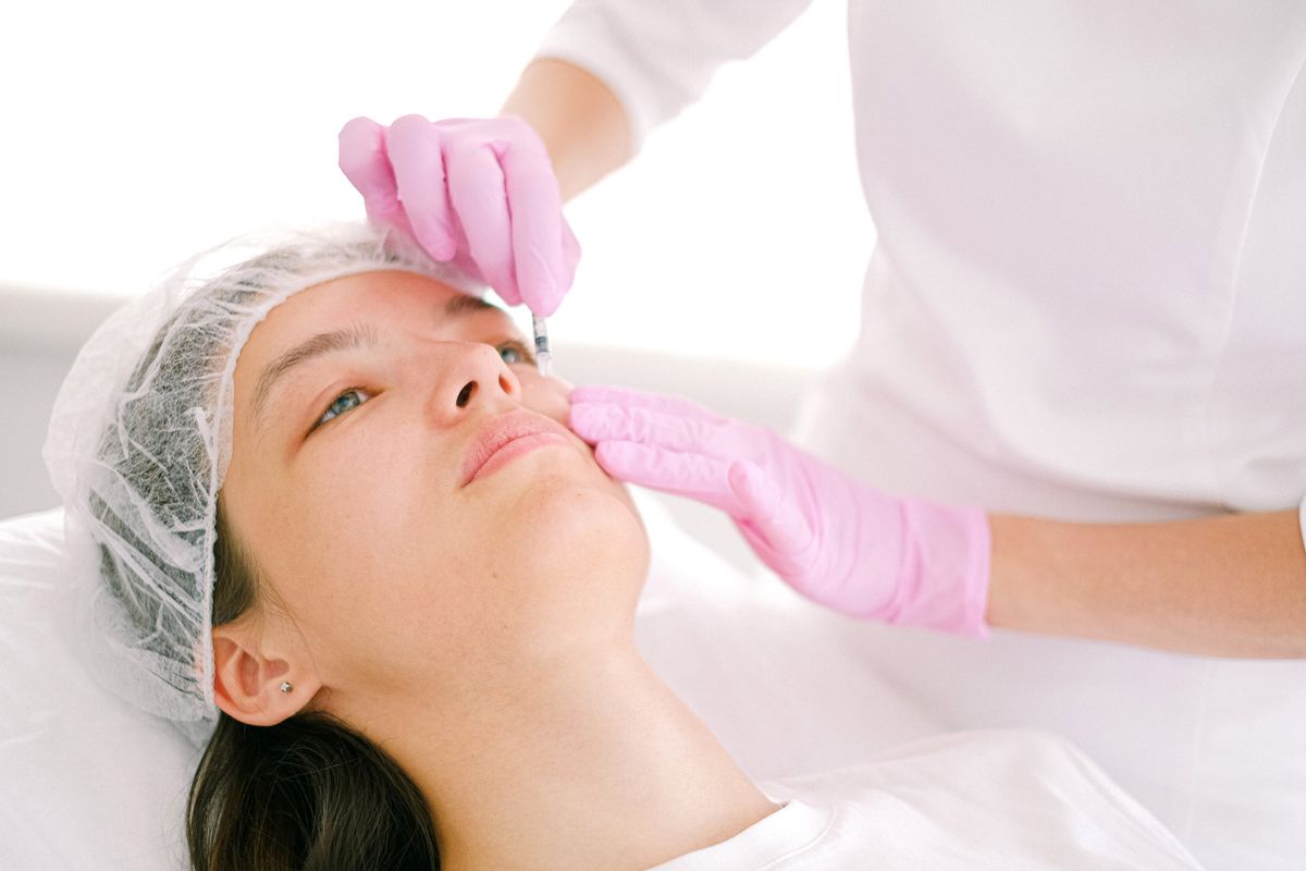 Cosmetic facial injection performed in a clinical setting; illustrative stock image.
