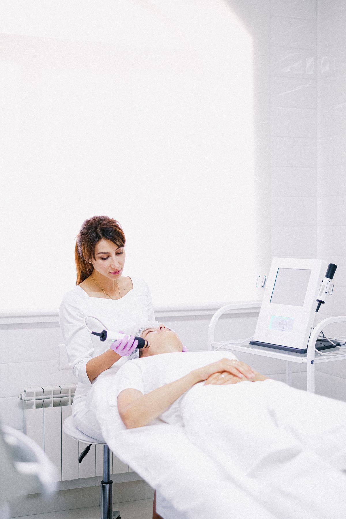 Facial laser treatment in a clinical setting; illustrative stock image.