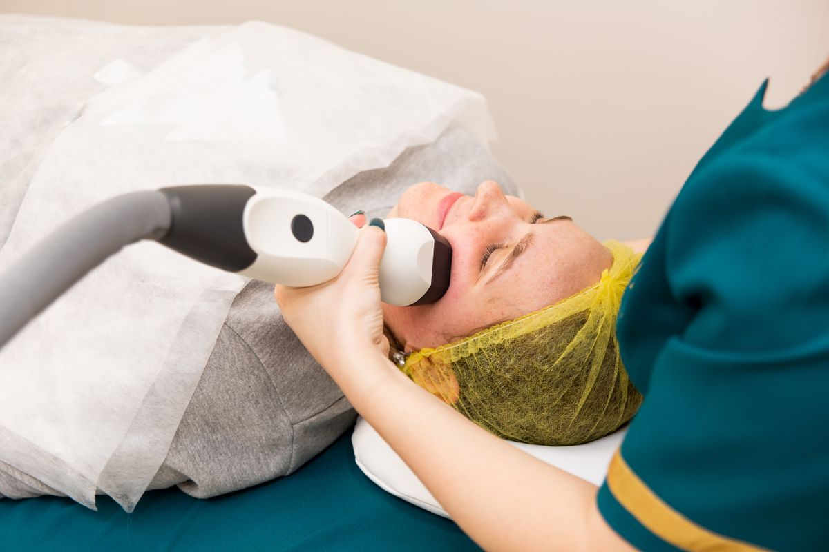 Device-assisted facial treatment in a clinic; illustrative stock image.